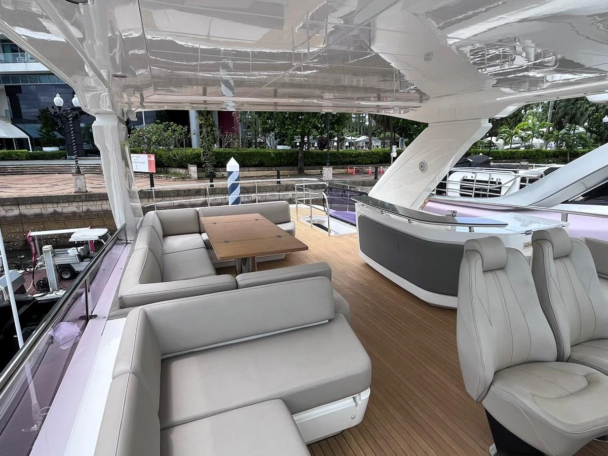The aft deck features a spacious seating area with plush cushions and a dining table, perfect for outdoor relaxation and meals. aboard PRINCESS CHLOE Yacht for Sale
