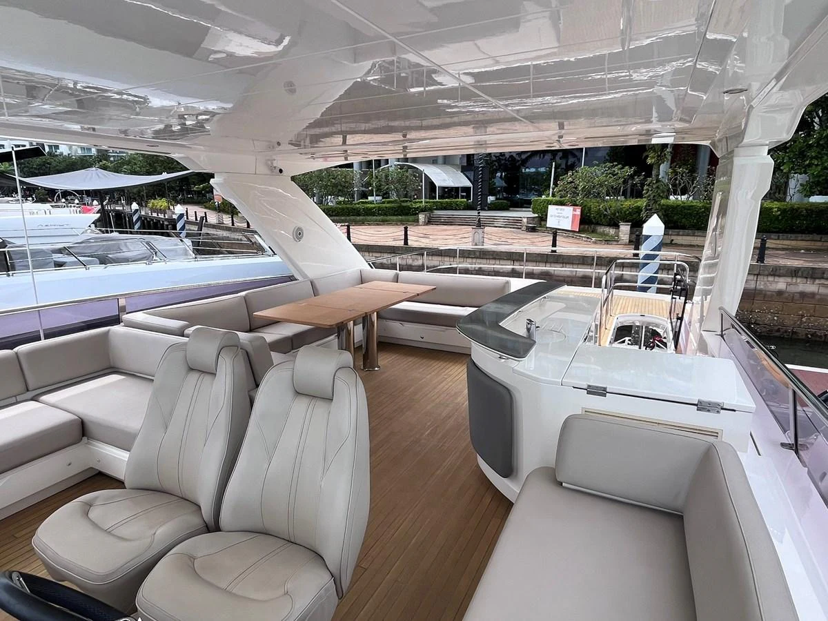 The aft deck features comfortable seating and a dining area with a sleek, modern design. aboard PRINCESS CHLOE Yacht for Sale