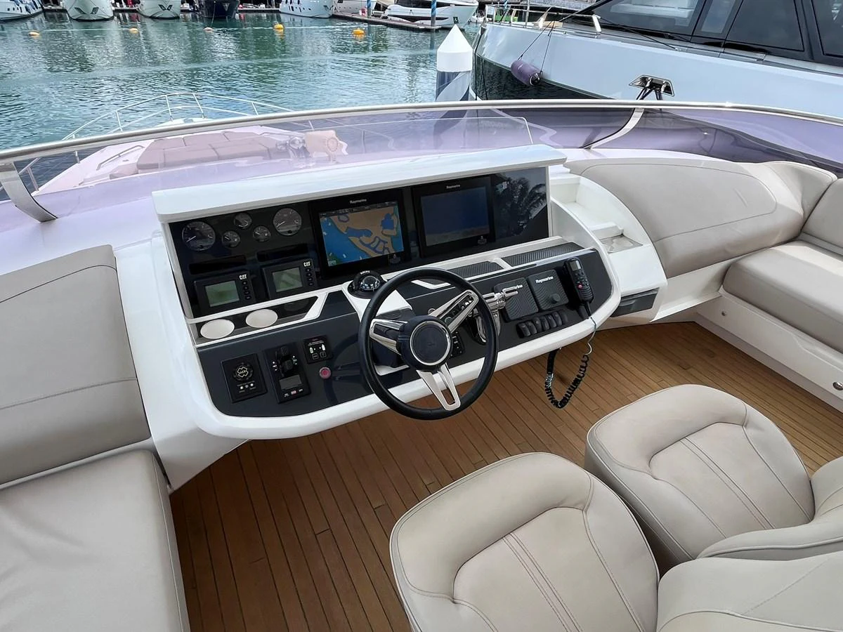 The helm station features modern navigation equipment and comfortable seating, offering a commanding view of the surroundings. aboard PRINCESS CHLOE Yacht for Sale