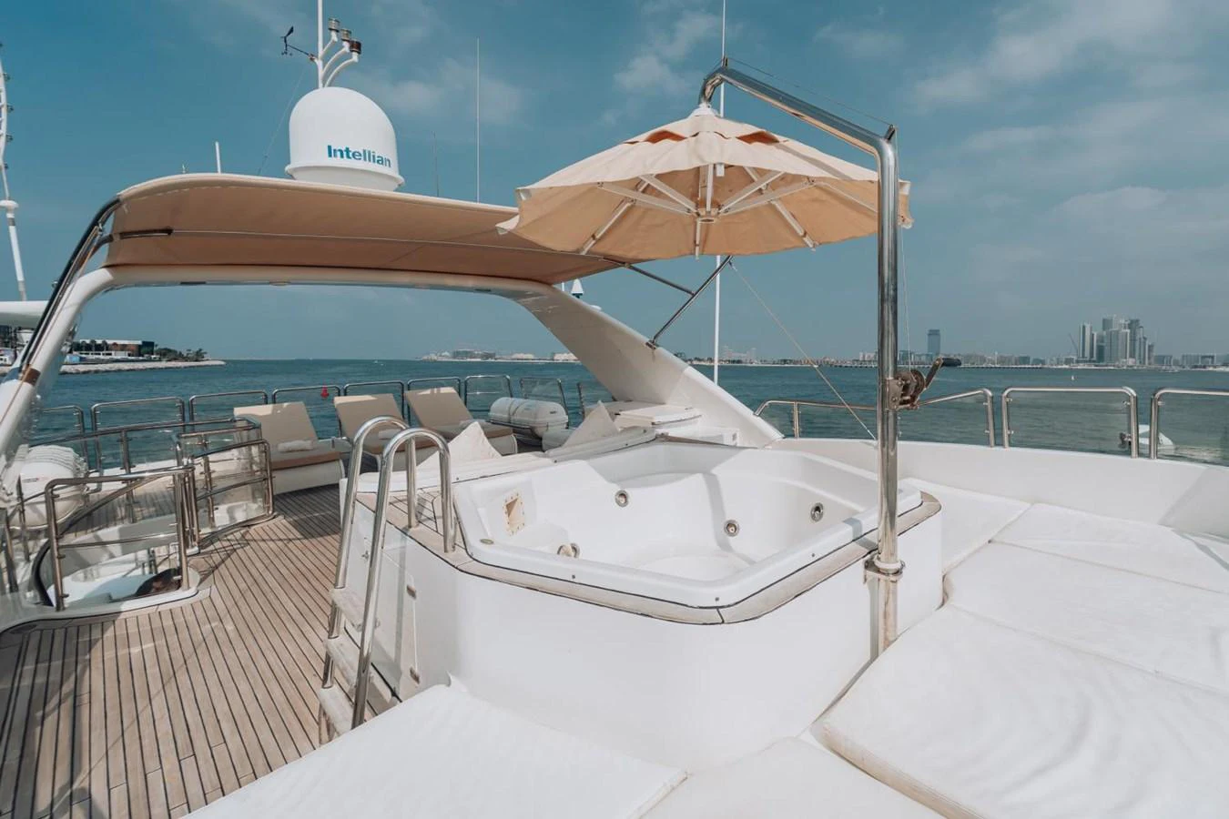 The sundeck features a luxurious jacuzzi and ample lounging space under a shaded canopy. aboard GALLUS Yacht for Sale