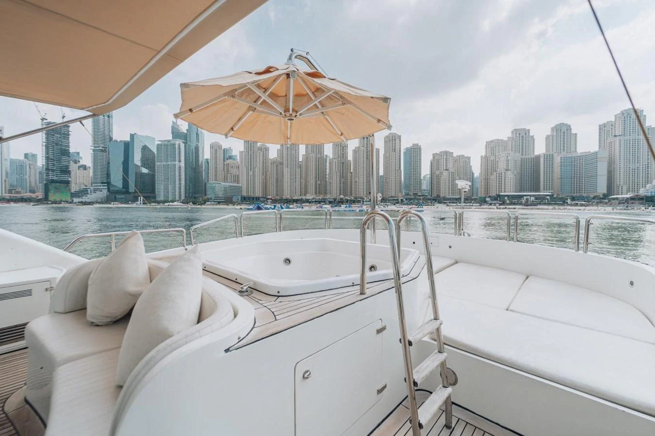The sundeck features a luxurious jacuzzi with a stunning cityscape backdrop. aboard GALLUS Yacht for Sale