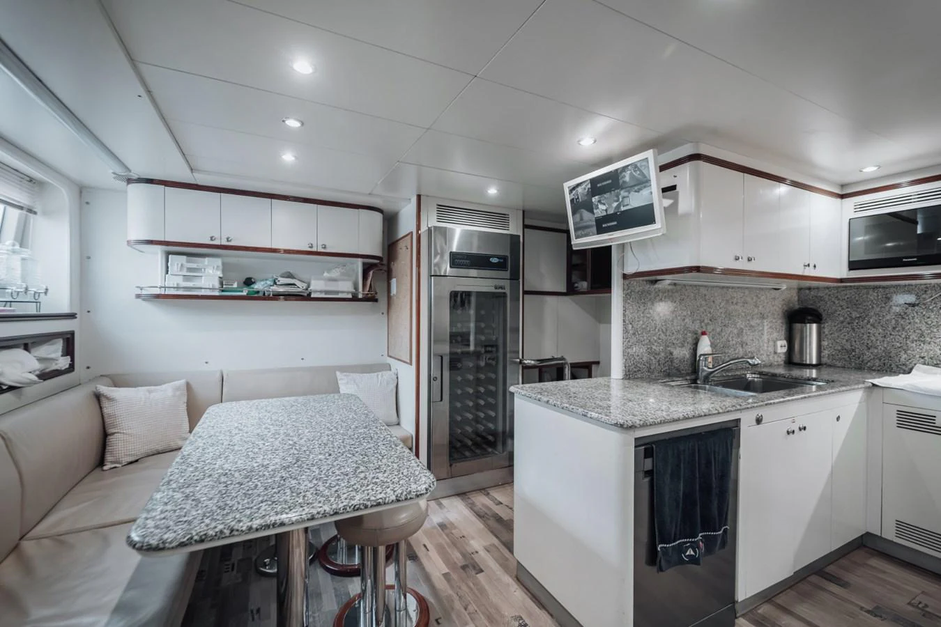 The galley features modern appliances, a cozy dining area, and ample storage space. aboard GALLUS Yacht for Sale
