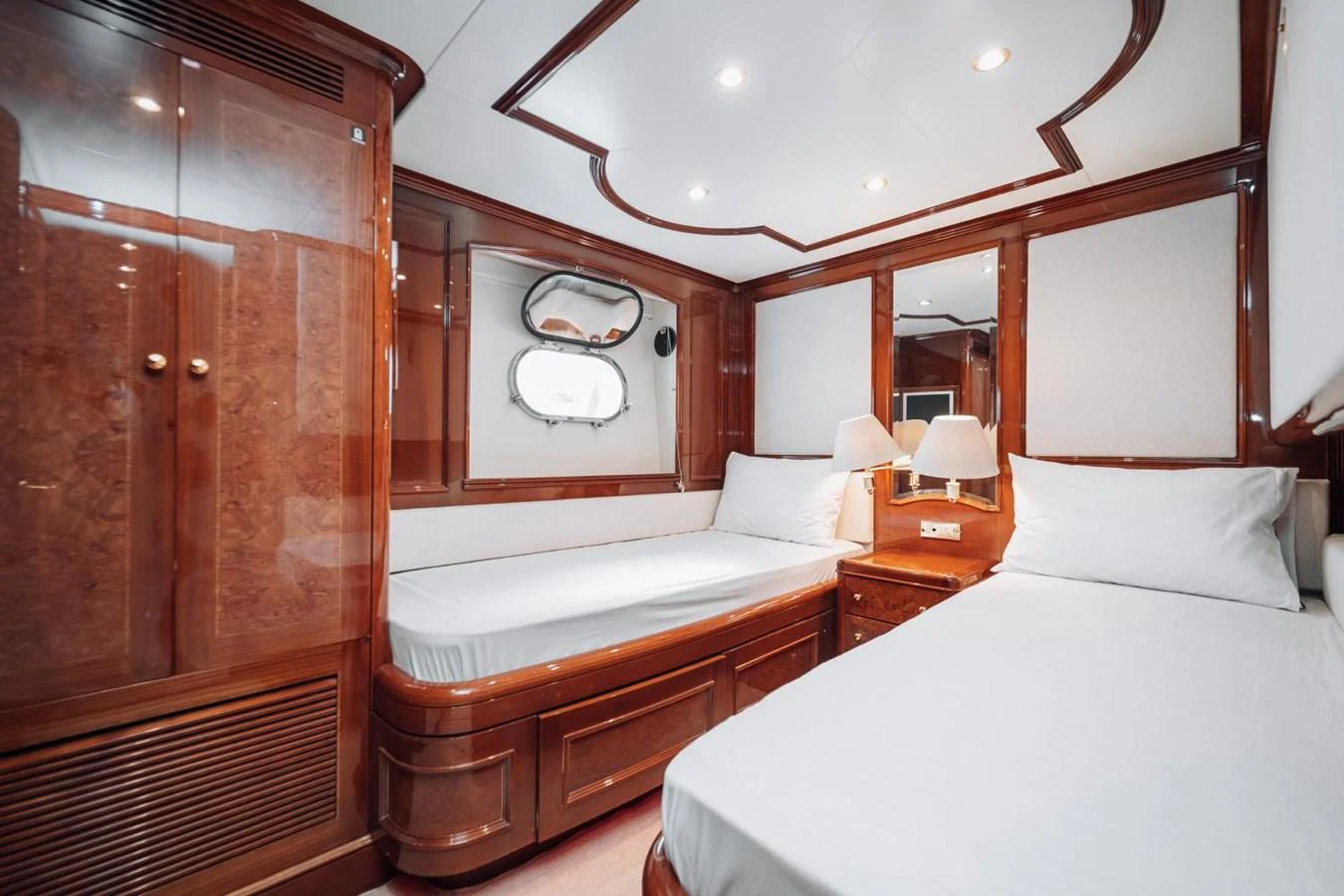 The guest stateroom features elegant wood finishes and comfortable twin beds. aboard GALLUS Yacht for Sale