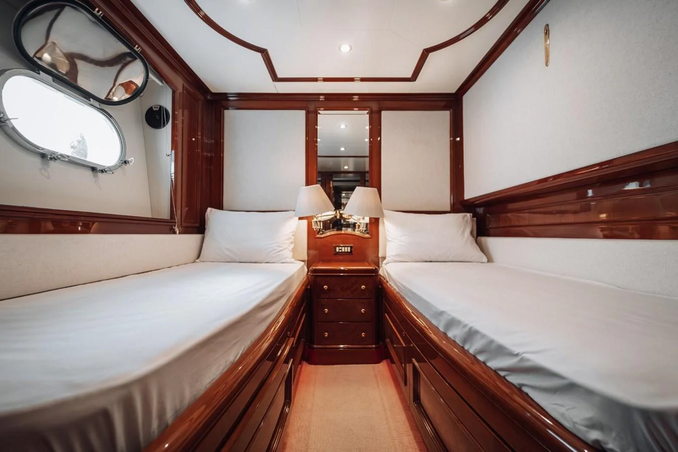 This cozy twin stateroom features elegant wood finishes and ample natural light. aboard GALLUS Yacht for Sale