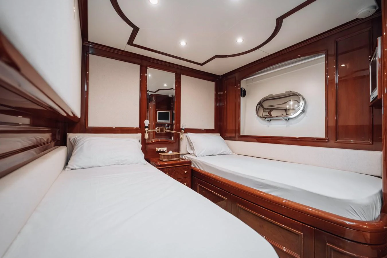 The twin cabin features two single beds with elegant wooden finishes and modern amenities. aboard GALLUS Yacht for Sale