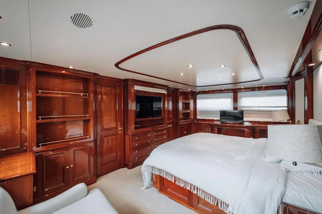 The master stateroom features luxurious wood paneling and a comfortable bed with elegant bedding. aboard GALLUS Yacht for Sale
