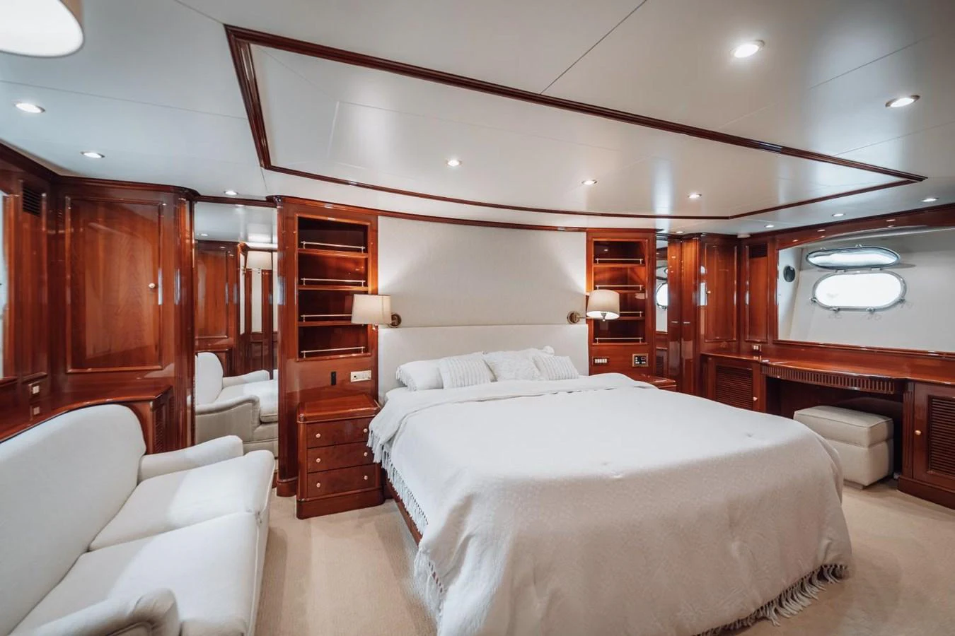 The master stateroom features a luxurious bed, elegant wood finishes, and ample natural light. aboard GALLUS Yacht for Sale
