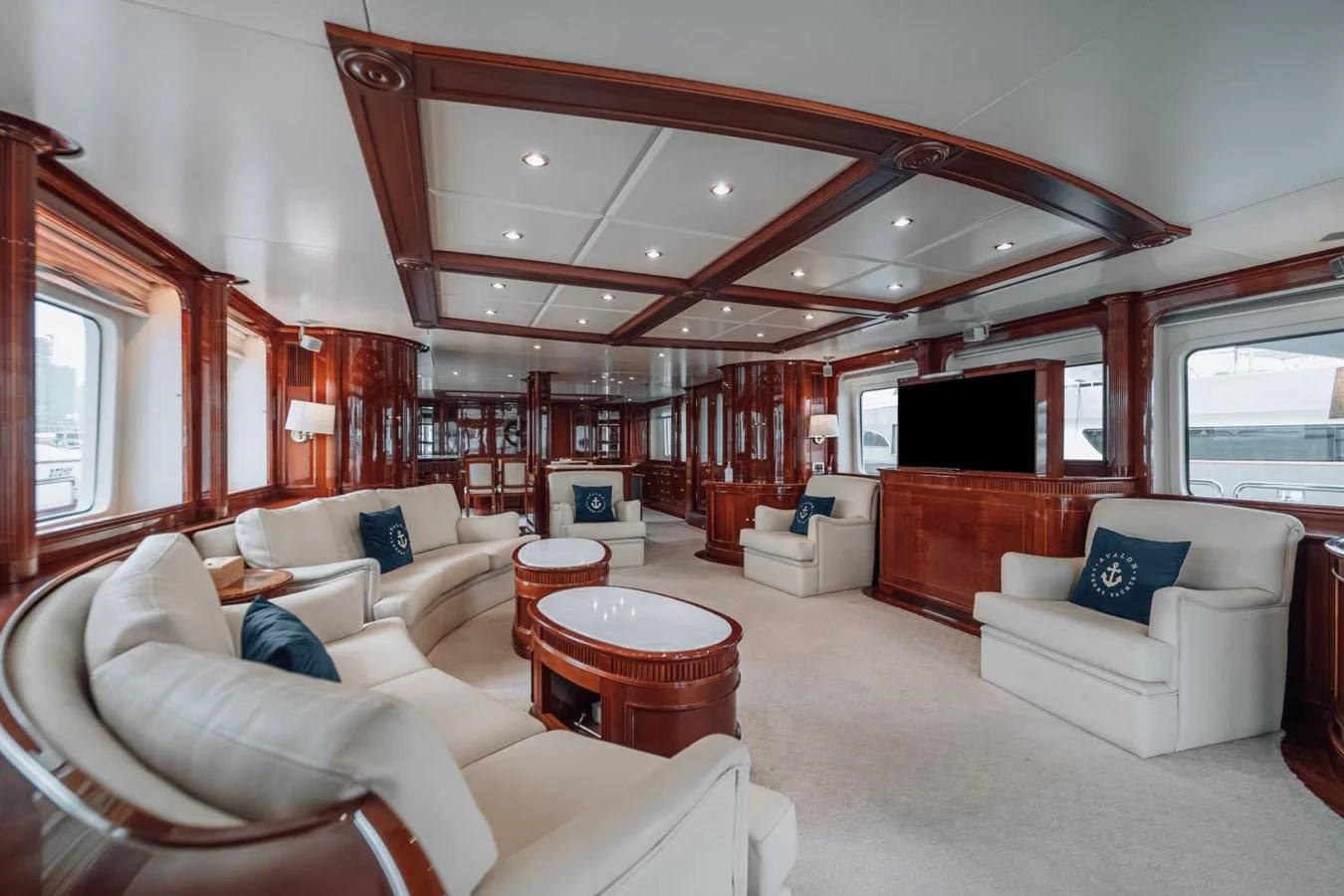The yacht's salon features elegant wood paneling, plush seating, and large windows for natural light. aboard GALLUS Yacht for Sale