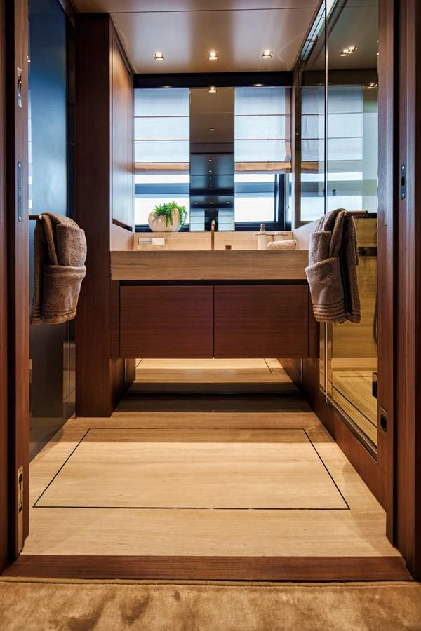 A luxurious yacht bathroom featuring modern fixtures and elegant wood finishes. aboard DESTINO Yacht for Sale