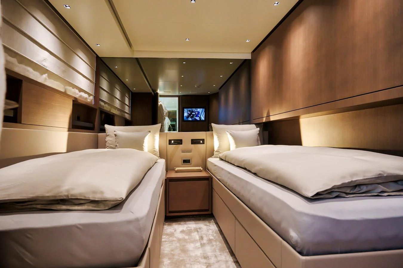 The twin stateroom features two comfortable beds with luxurious bedding and modern lighting. aboard DESTINO Yacht for Sale