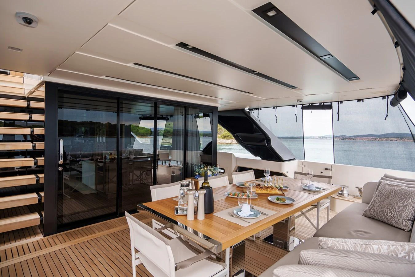 The aft deck features a stylish dining area with a large table and comfortable seating, perfect for alfresco meals with a view. aboard DESTINO Yacht for Sale