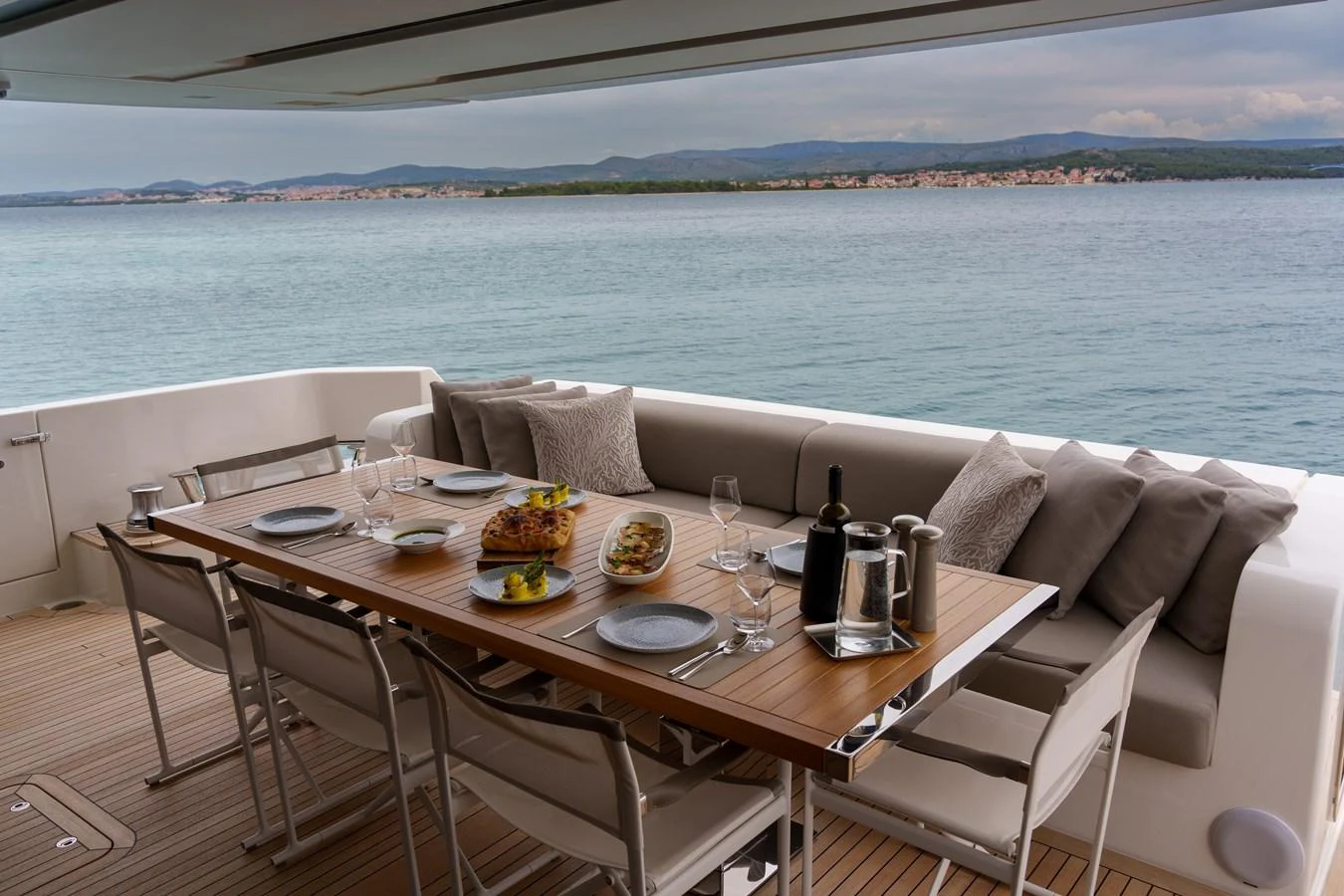 The aft deck features an elegant dining area with a stunning sea view. aboard DESTINO Yacht for Sale