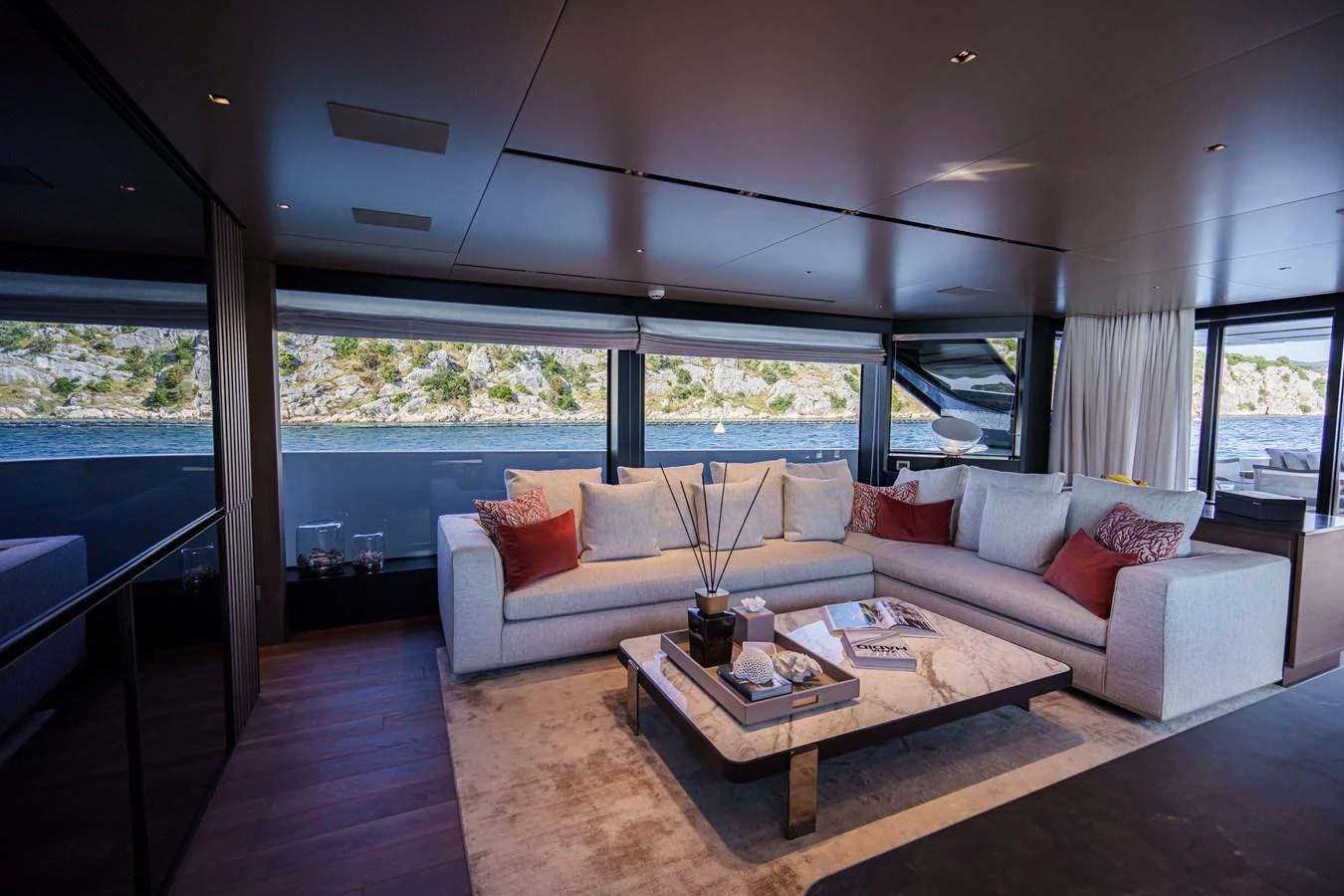 The salon features a spacious and elegant seating area with large windows offering stunning views. aboard DESTINO Yacht for Sale