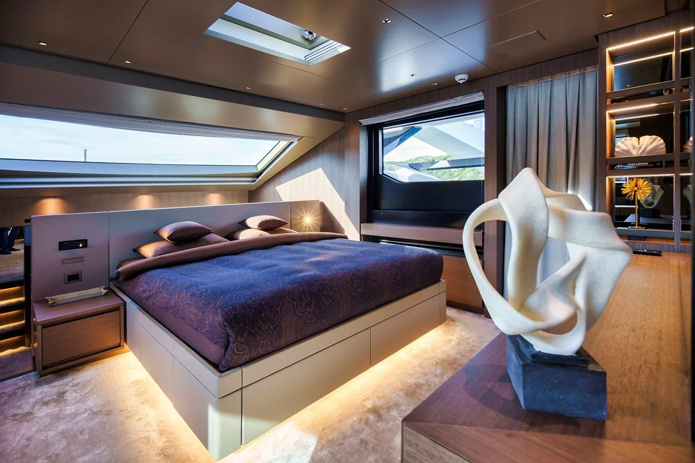 The master stateroom features a luxurious bed, modern decor, and ample natural light. aboard DESTINO Yacht for Sale