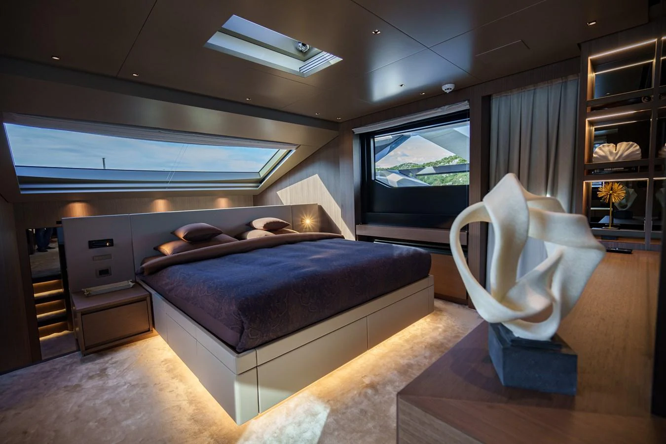 The master stateroom features a luxurious bed with elegant lighting and modern decor. aboard DESTINO Yacht for Sale