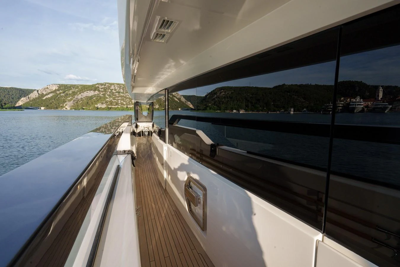 The side deck offers a sleek walkway with stunning views of the surrounding waters and landscape. aboard DESTINO Yacht for Sale