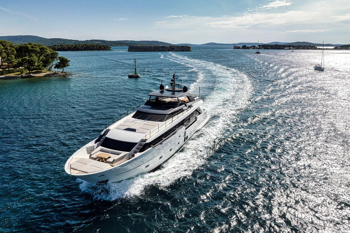 A sleek yacht cruises through pristine blue waters, showcasing its elegant design and luxurious amenities. aboard DESTINO Yacht for Sale