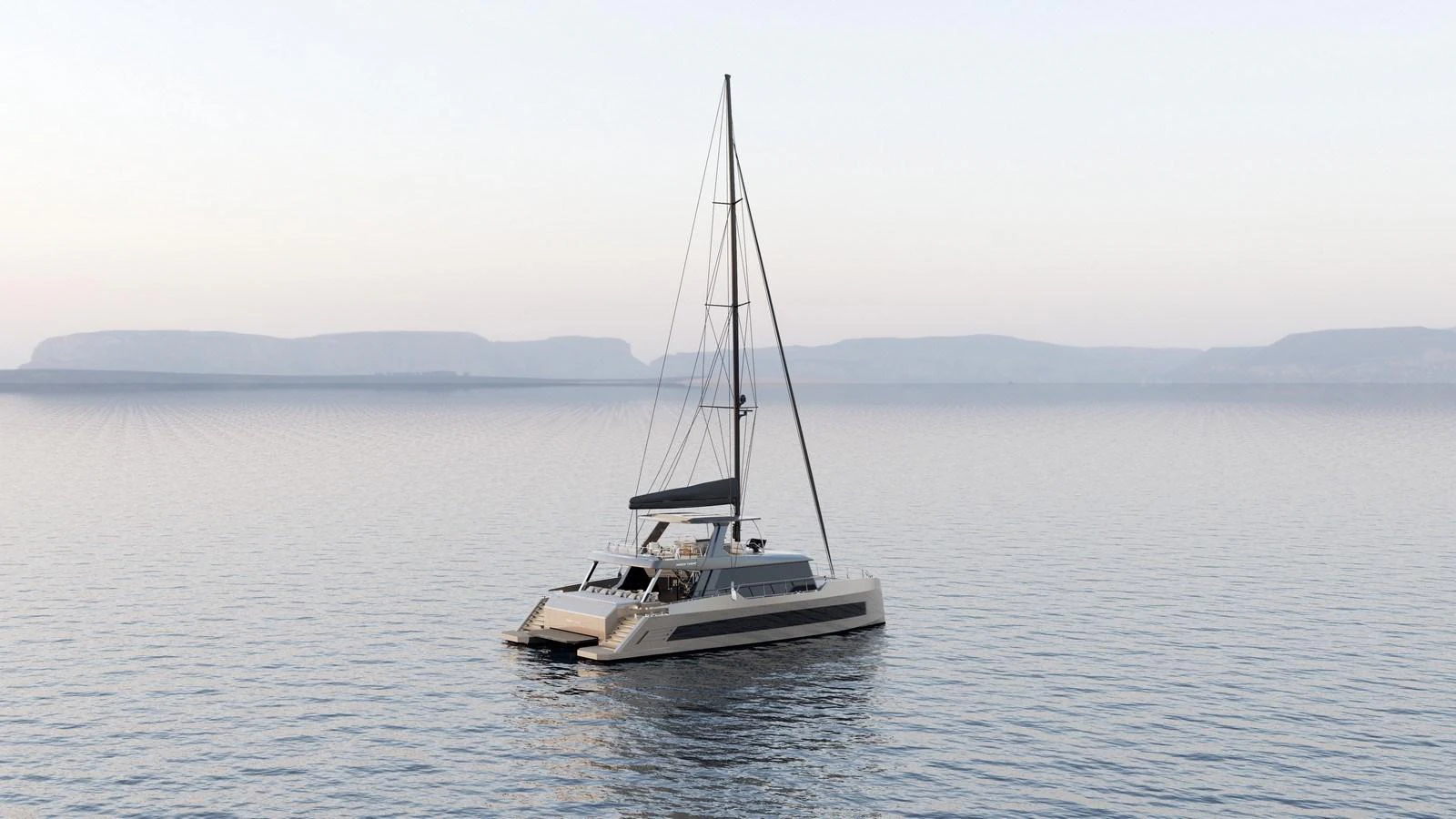 A sleek catamaran yacht glides peacefully on calm waters with a serene backdrop of distant hills. aboard MOON 70 SAIL Yacht for Sale