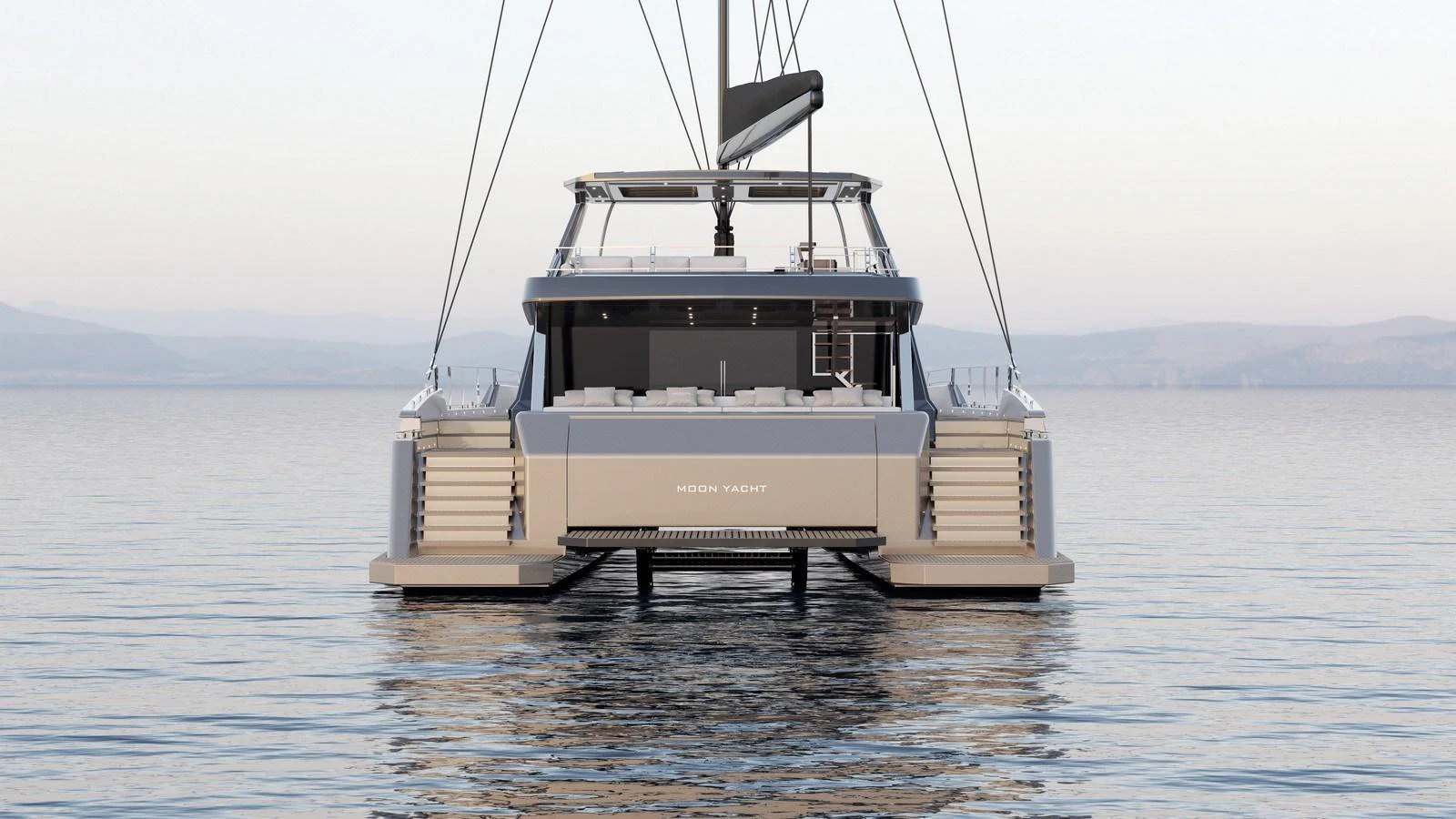 A sleek yacht is seen from the rear, floating calmly on the water. aboard MOON 70 SAIL Yacht for Sale