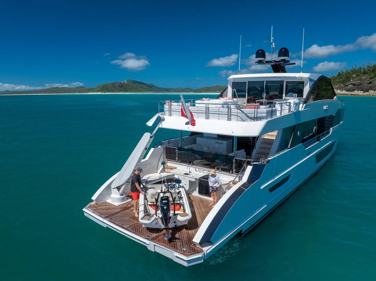 A sleek yacht with an inviting aft deck cruising in clear blue waters. aboard G Yacht for Sale