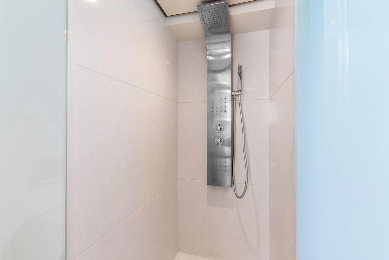 A sleek, modern shower with a stainless steel fixture in a yacht bathroom. aboard G Yacht for Sale