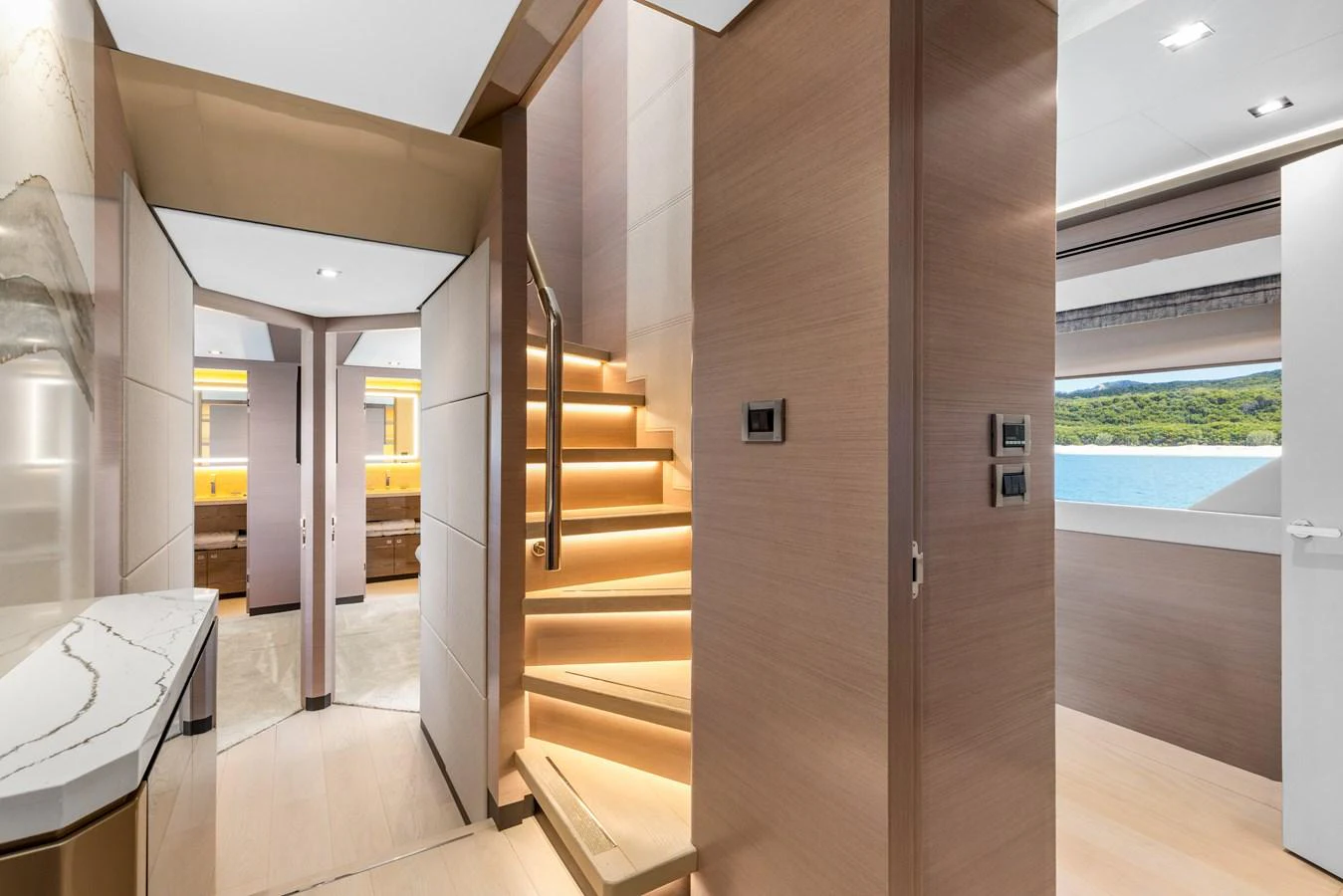 The yacht's interior features a modern staircase with elegant lighting and a sleek design. aboard G Yacht for Sale