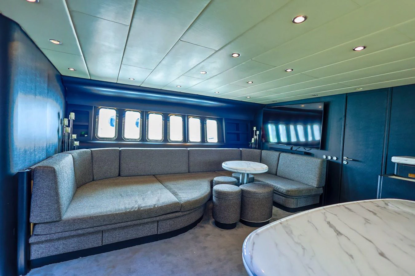 The yacht's interior features a spacious seating area with modern furnishings and ample natural light. aboard SEA SQUIRTER Yacht for Sale