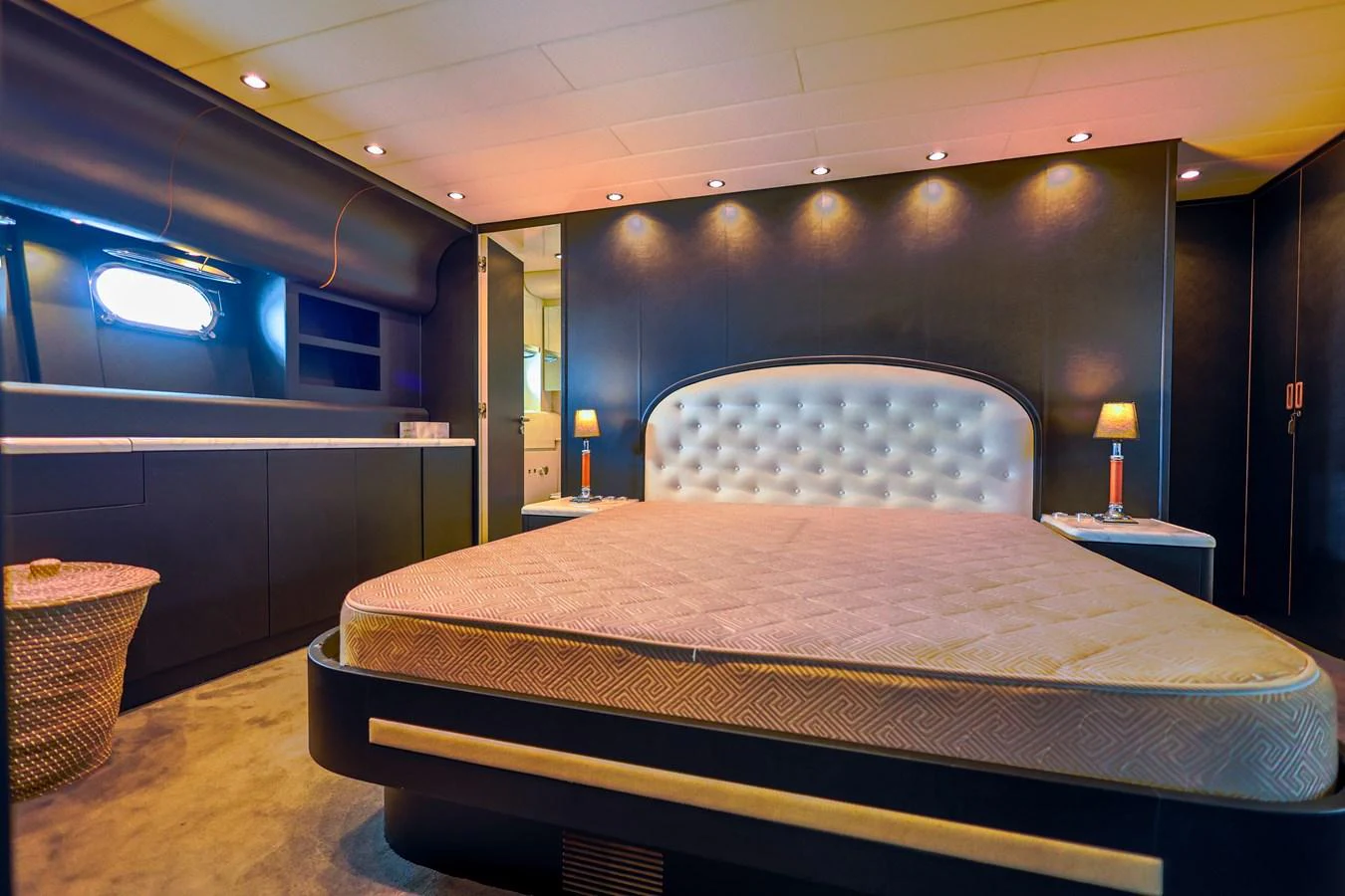 The master stateroom features a luxurious bed with elegant lighting and modern furnishings. aboard SEA SQUIRTER Yacht for Sale