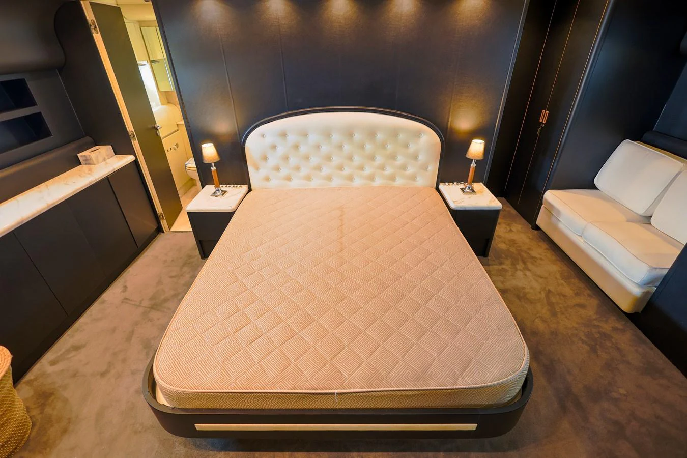 The master stateroom features a luxurious bed with elegant lighting and modern furnishings. aboard SEA SQUIRTER Yacht for Sale