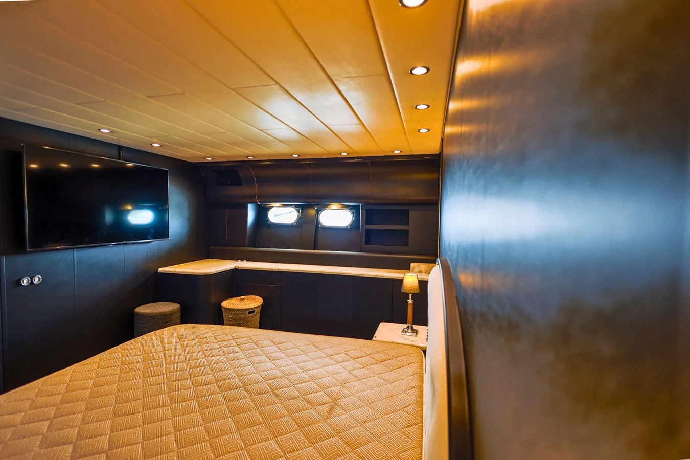 A luxurious stateroom featuring a large bed, ambient lighting, and modern decor. aboard SEA SQUIRTER Yacht for Sale