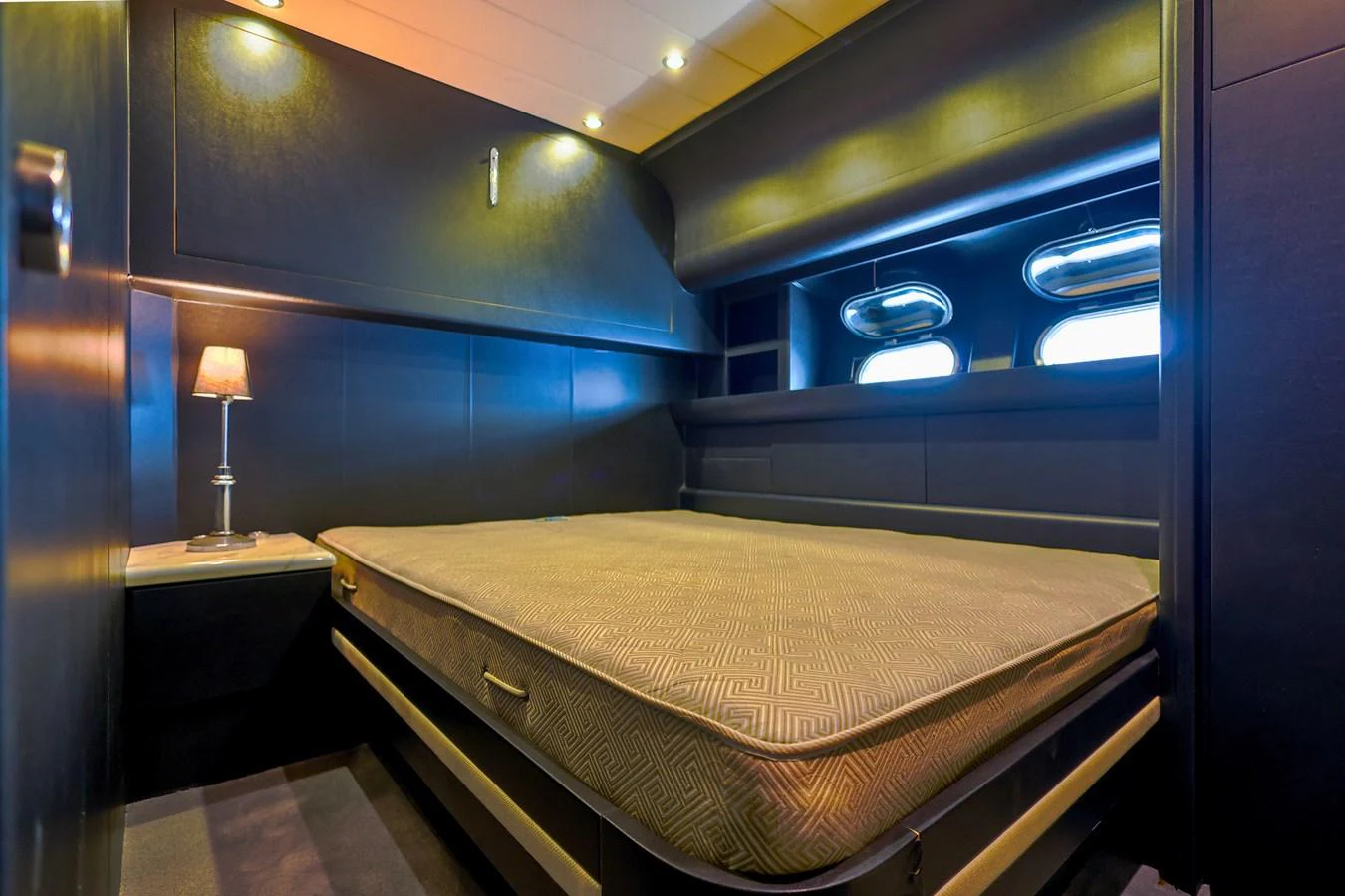A cozy stateroom with a large bed and ambient lighting. aboard SEA SQUIRTER Yacht for Sale