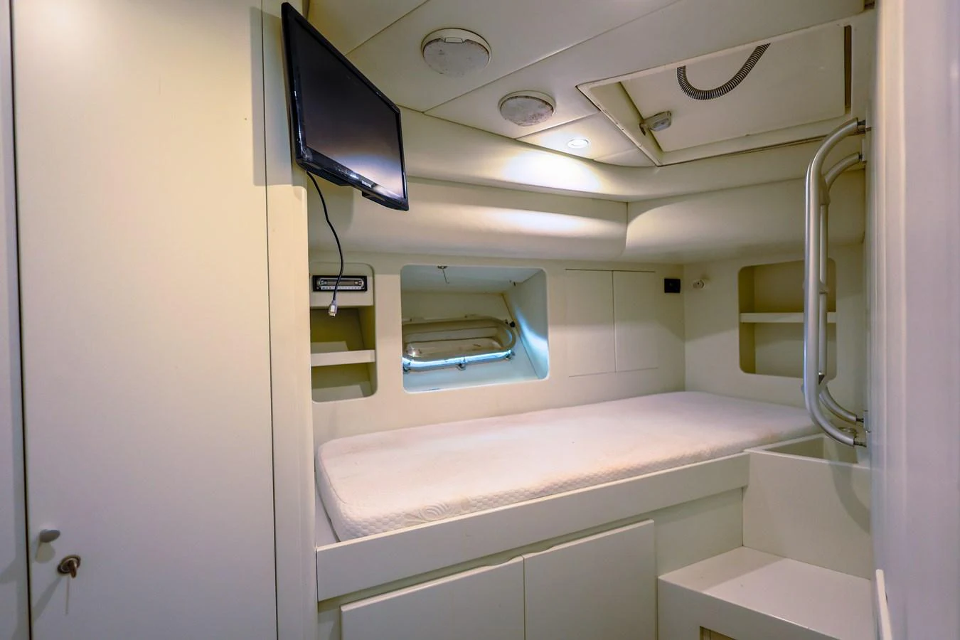 Compact crew quarters with a single bed and built-in storage. aboard SEA SQUIRTER Yacht for Sale