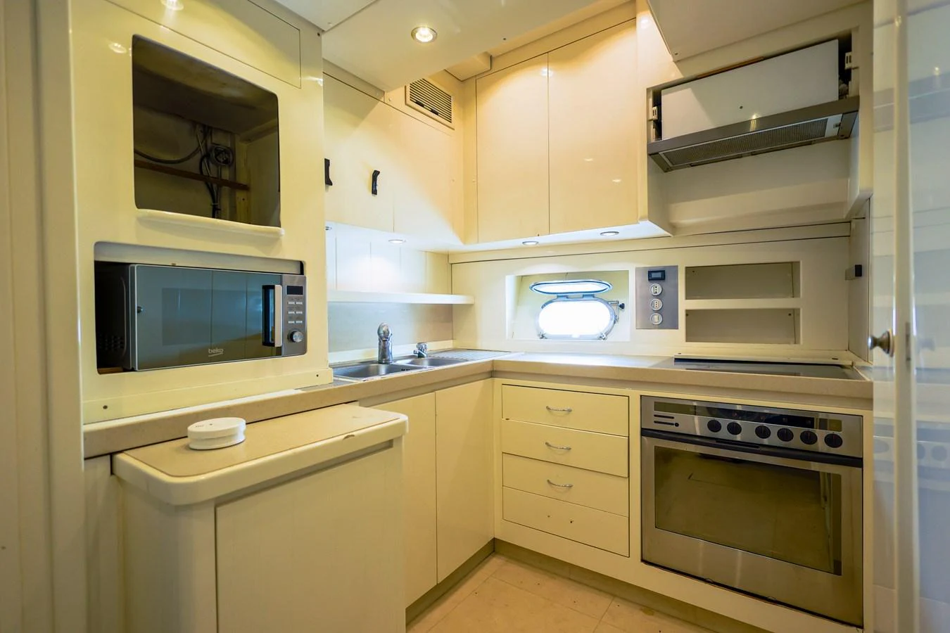 The galley features modern appliances and ample storage in a compact, efficient layout. aboard SEA SQUIRTER Yacht for Sale