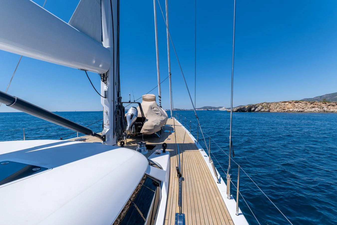 The yacht's deck offers a stunning view of the open sea under a clear blue sky. aboard EPIPHANY Yacht for Sale