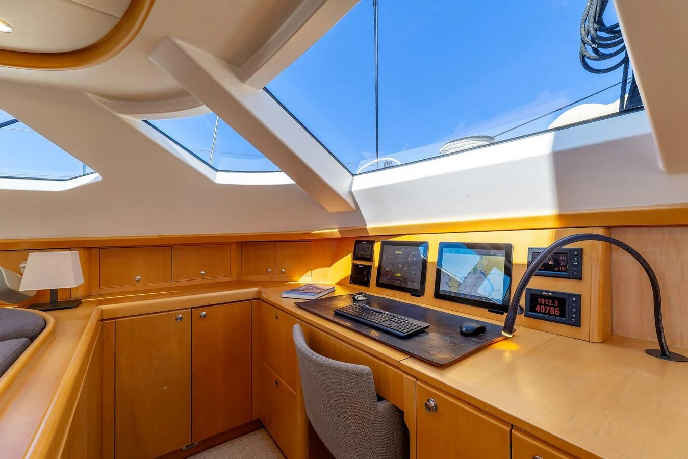 The helm station features modern navigation equipment and ample natural light from overhead windows. aboard EPIPHANY Yacht for Sale