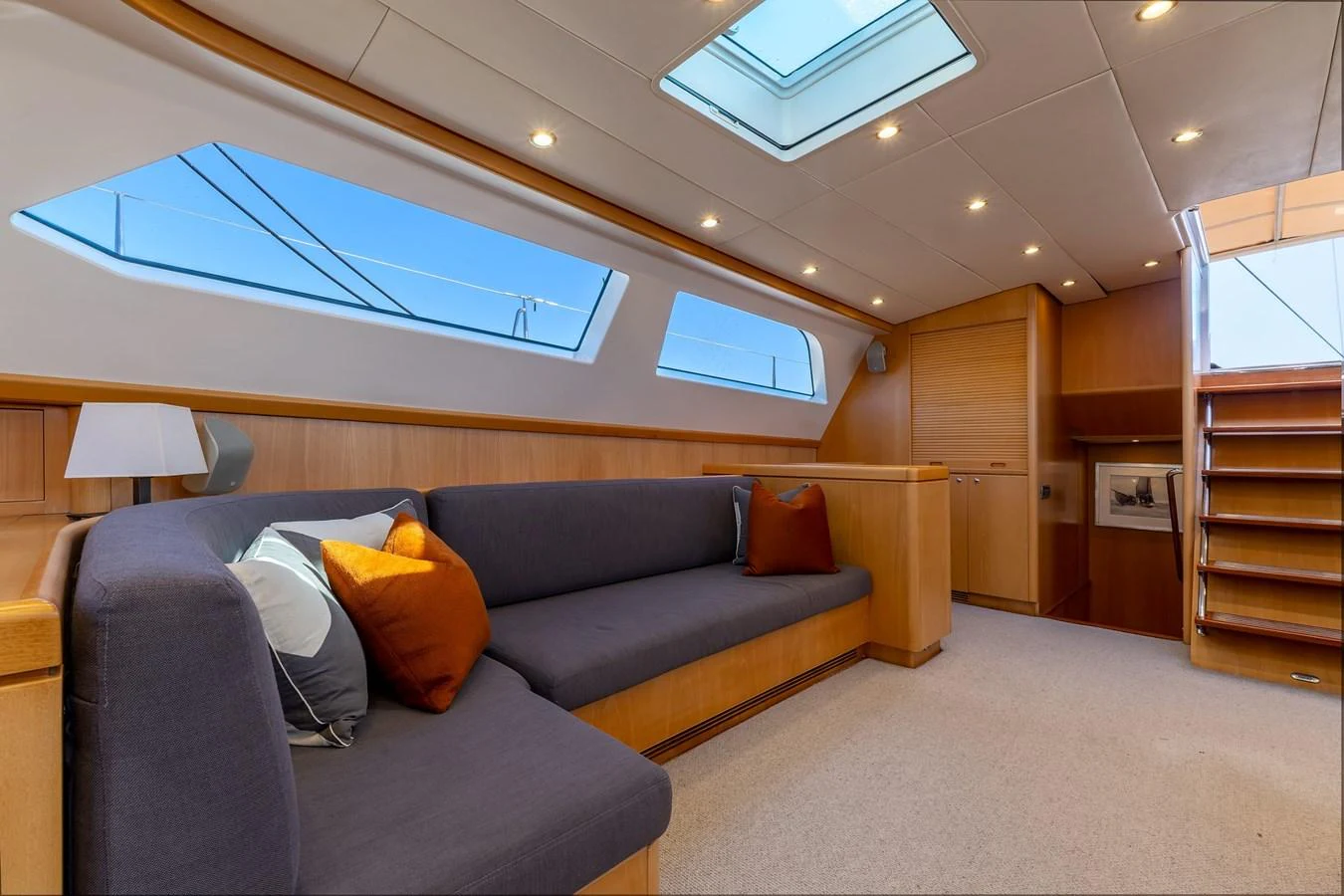 The yacht's interior features a spacious and well-lit seating area with modern furnishings and large windows. aboard EPIPHANY Yacht for Sale