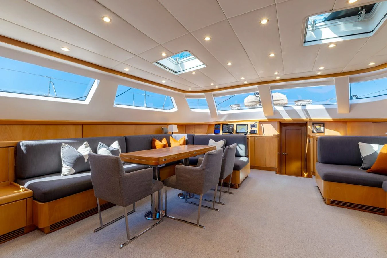 The saloon offers a spacious and well-lit area with comfortable seating and a dining table. aboard EPIPHANY Yacht for Sale