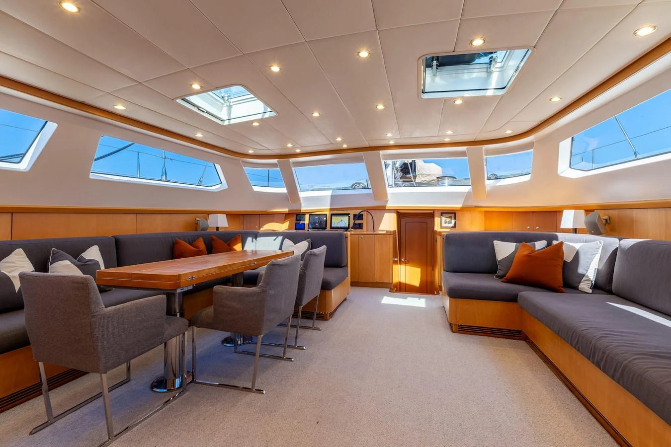 The salon features a spacious and well-lit seating area with modern furnishings and ample natural light. aboard EPIPHANY Yacht for Sale
