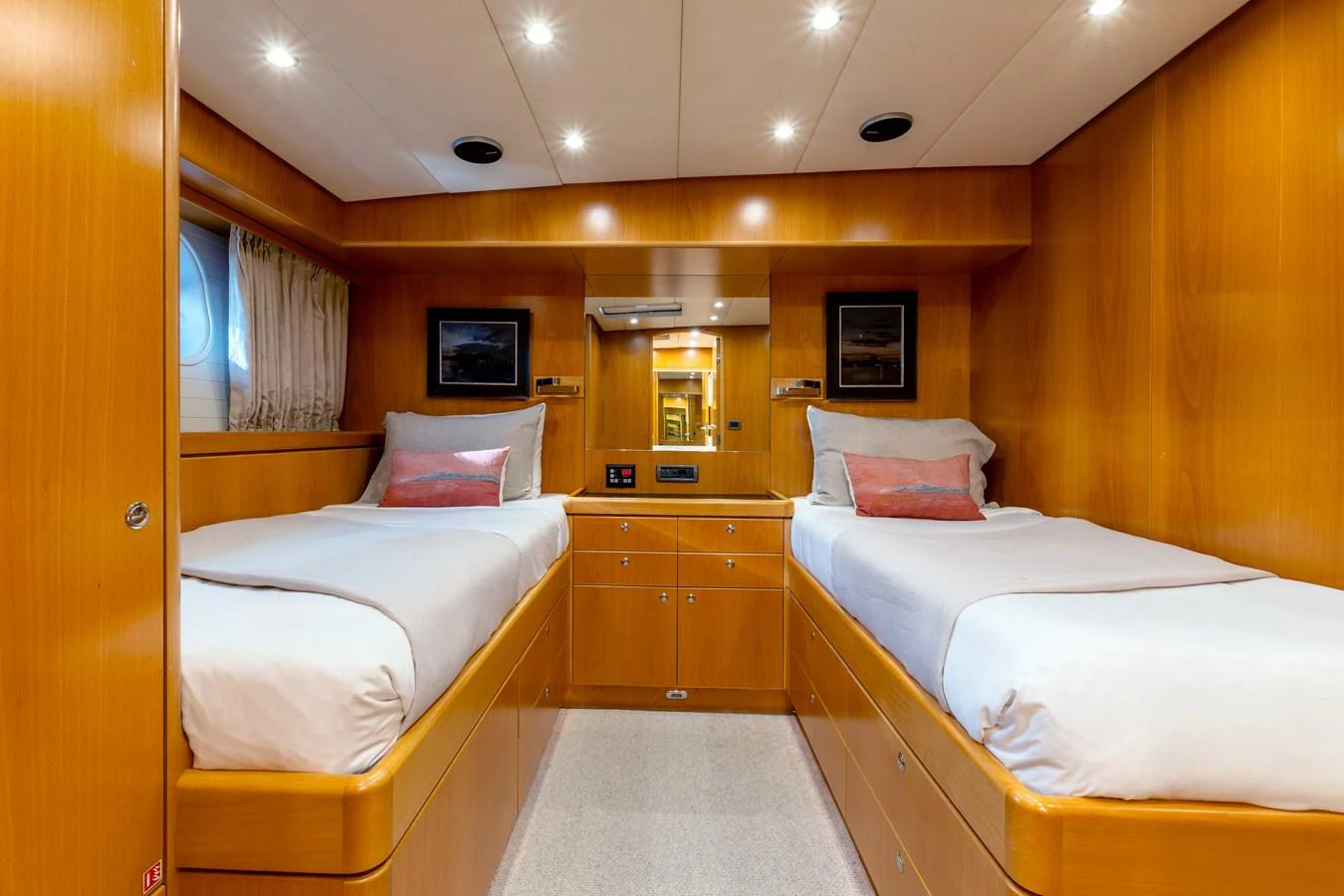 The twin stateroom features two comfortable single beds with elegant wood paneling and soft lighting. aboard EPIPHANY Yacht for Sale