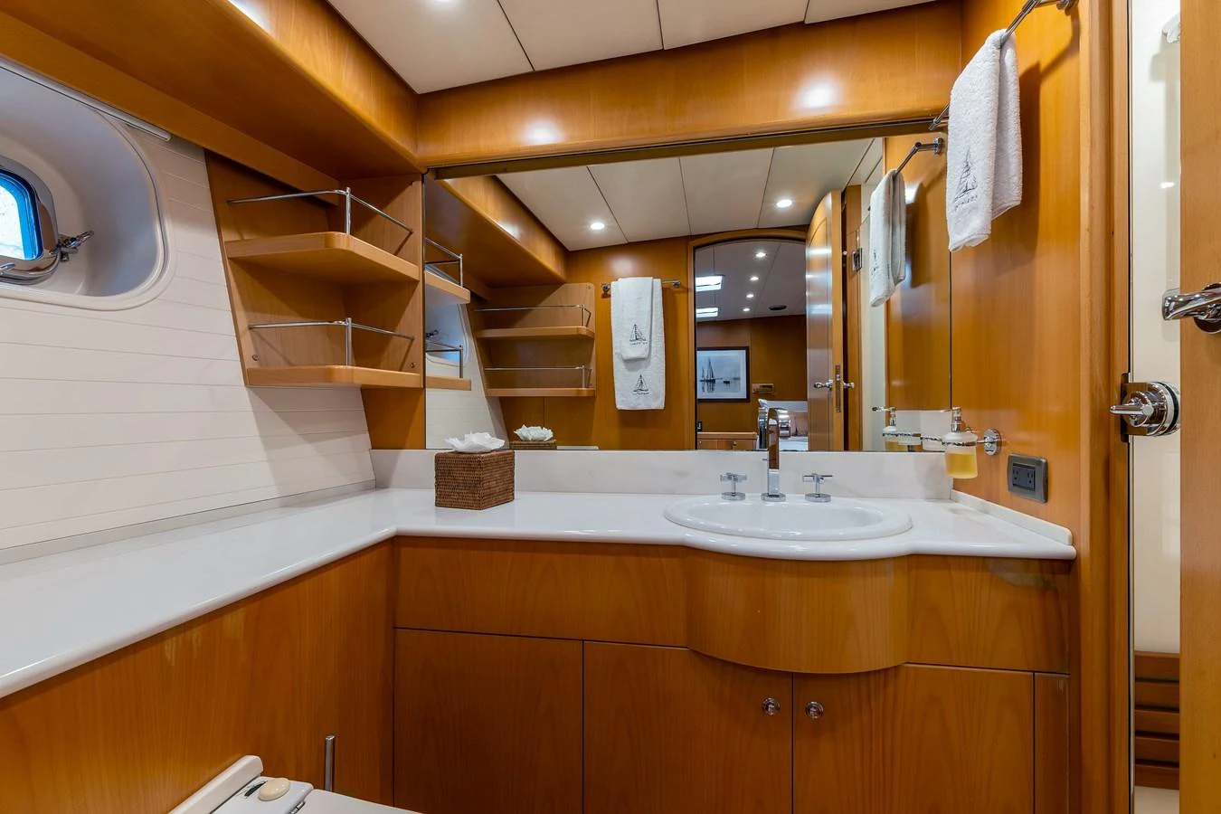 The yacht's bathroom features a sleek design with wooden cabinetry and modern fixtures. aboard EPIPHANY Yacht for Sale