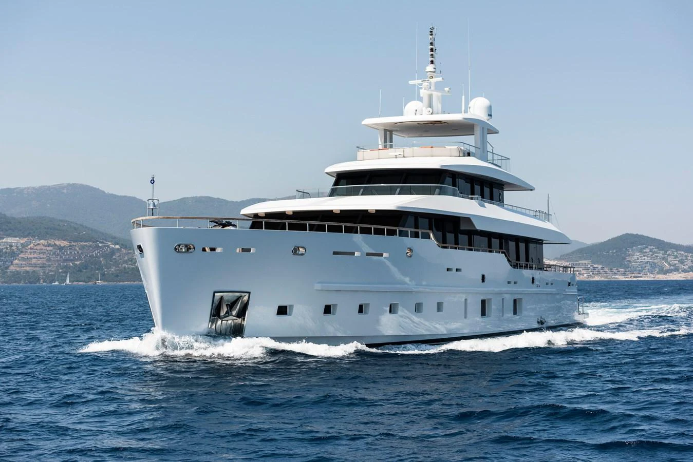 A luxurious yacht cruises through the serene blue waters, showcasing its sleek design and modern amenities. aboard K Yacht for Sale