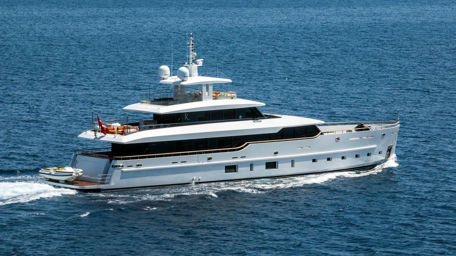 A sleek and modern yacht cruises gracefully on the open sea. aboard K Yacht for Sale