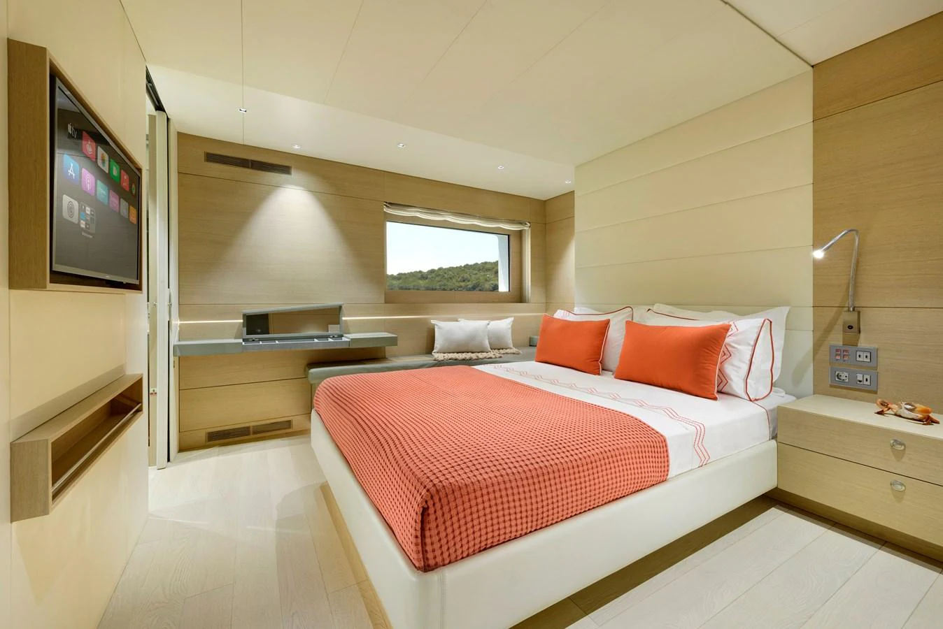 The stateroom features a comfortable bed with vibrant orange accents and modern amenities. aboard K Yacht for Sale