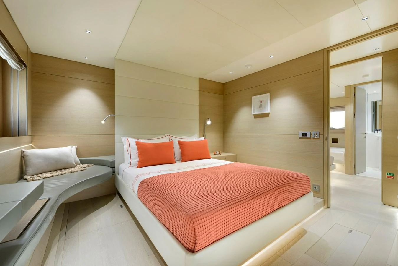A luxurious stateroom featuring a comfortable bed with orange accents and modern furnishings. aboard K Yacht for Sale