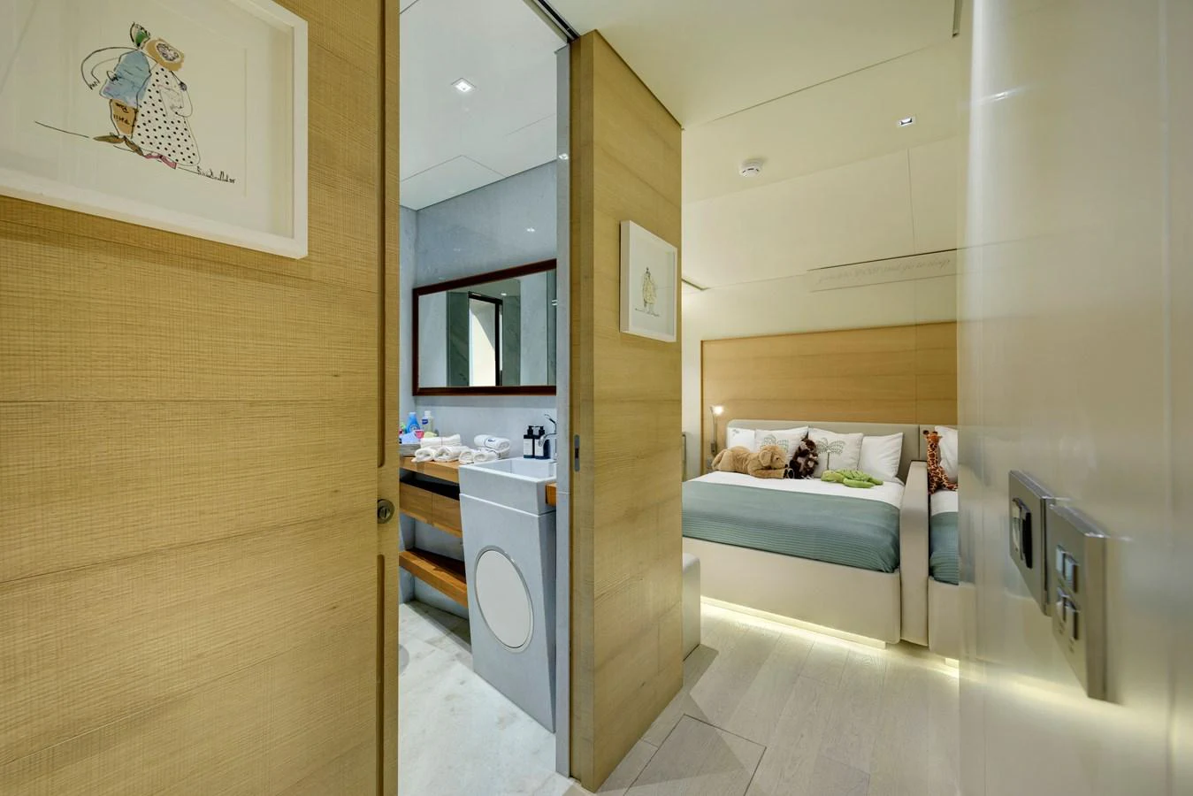 A cozy stateroom with an en-suite bathroom, featuring modern decor and soft lighting. aboard K Yacht for Sale