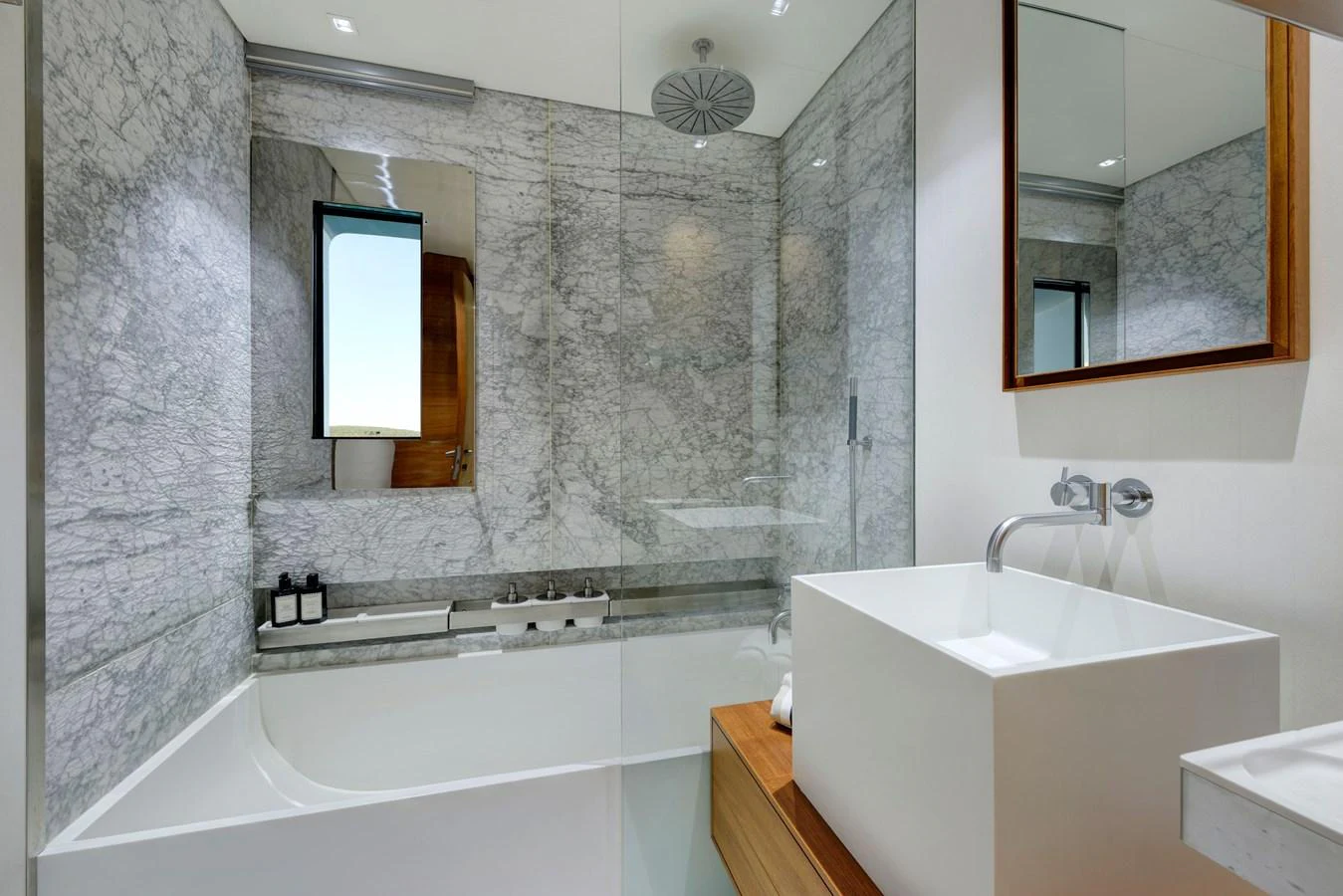 The yacht's bathroom features a modern design with a sleek bathtub and elegant fixtures. aboard K Yacht for Sale