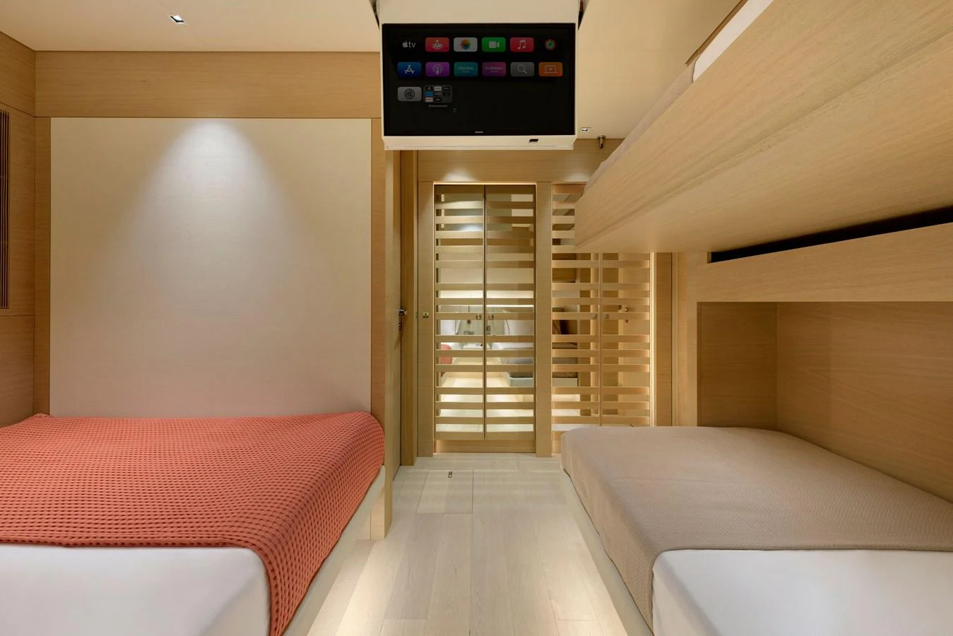The guest cabin features a modern design with twin beds and a sleek entertainment system. aboard K Yacht for Sale