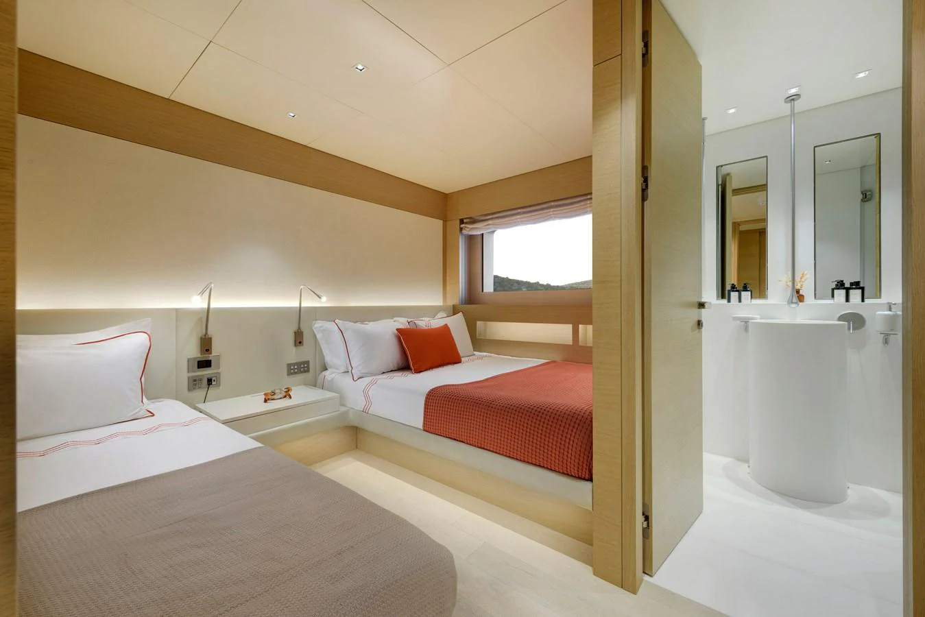 The guest stateroom features twin beds with modern, minimalist decor and ample natural light. aboard K Yacht for Sale