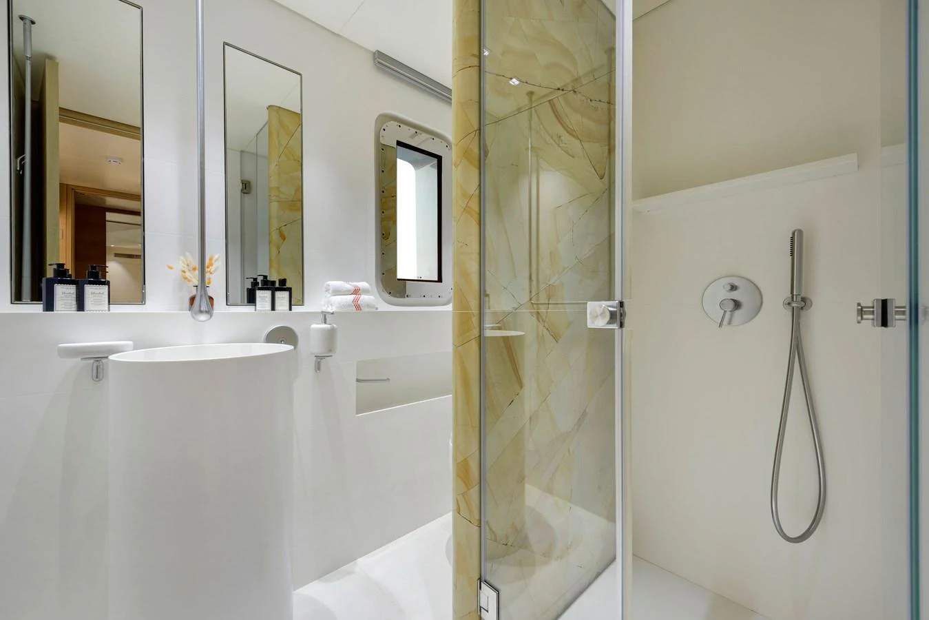 The yacht's bathroom features a modern design with a sleek shower and elegant fixtures. aboard K Yacht for Sale
