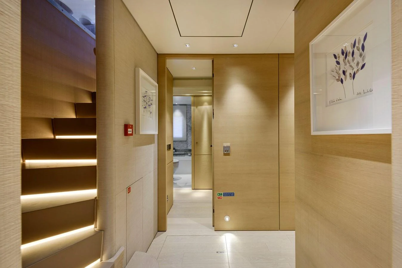 The yacht's interior hallway features modern decor with soft lighting and elegant artwork. aboard K Yacht for Sale